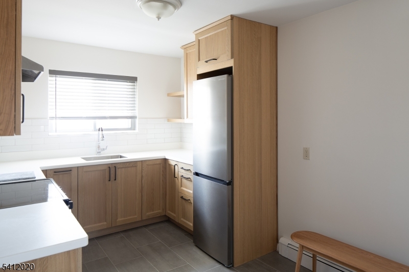197 North Beverwyck Road, Unit 10 Lake Hiawatha, NJ 07034 - Photo 7 of 18 a kitchen with a refrigerator and a sink