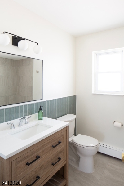 197 North Beverwyck Road, Unit 10 Lake Hiawatha, NJ 07034 - Photo 10 of 18 a bathroom with a sink a toilet and a mirror