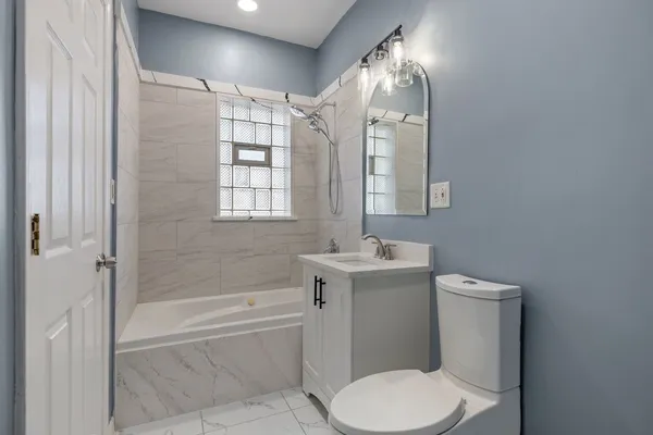 a bathroom with a sink toilet and shower