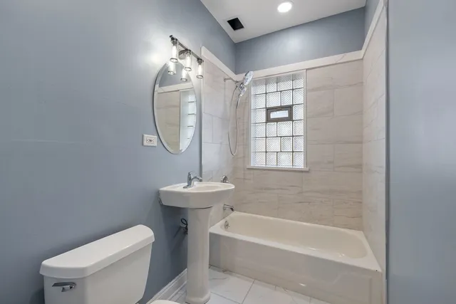 a bathroom with a toilet a sink and bathtub