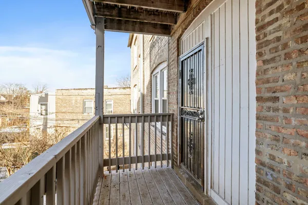 a view of balcony with wooden floor