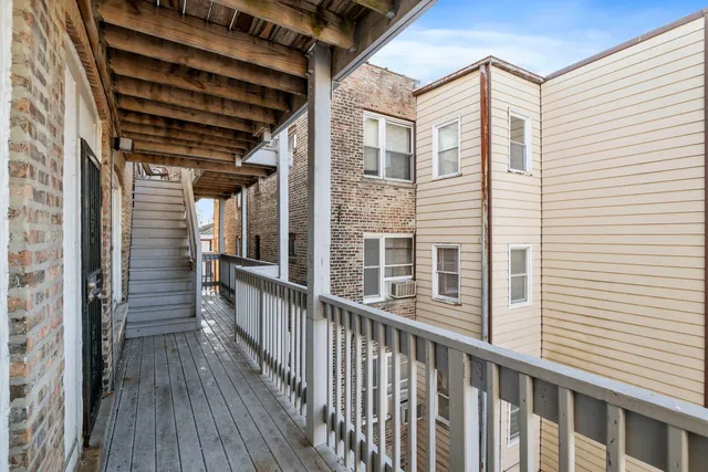 a view of a balcony with wooden floor