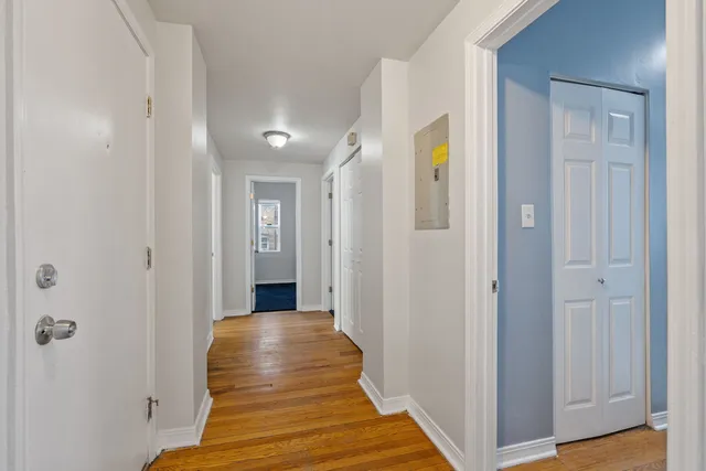 a view of a hallway with wooden floor and entryway