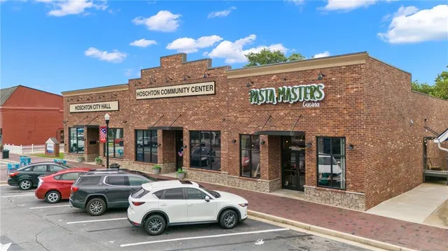 a view of a brick house with large windows and a table