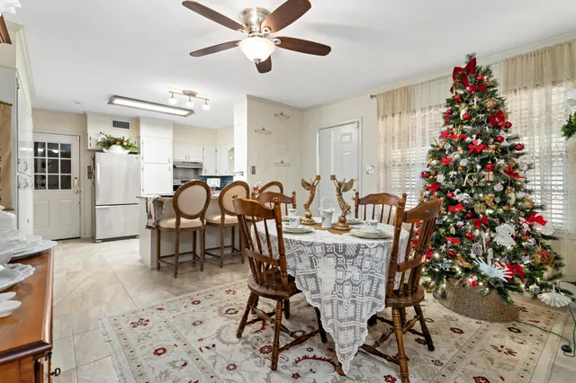 a view of a dining room with furniture and chandelier