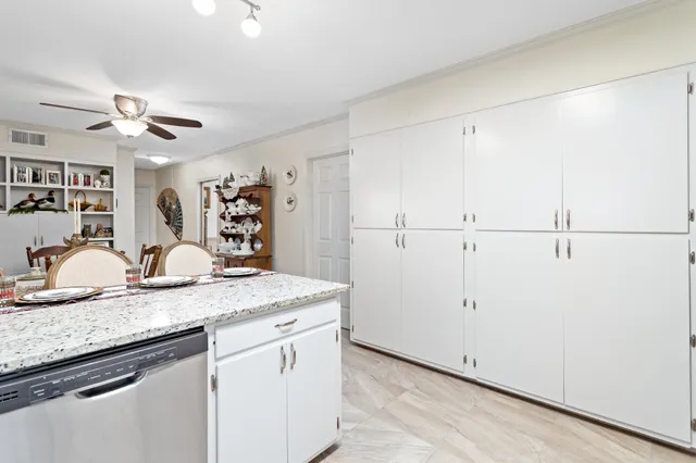 a kitchen with granite countertop cabinets and wooden floor