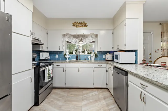 a kitchen with a sink stove and refrigerator