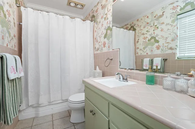 a bathroom with a granite countertop sink a toilet and a mirror