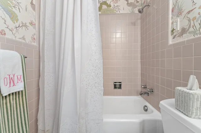a bathroom with a bathtub and shower