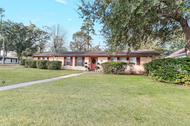a front view of house with yard and green space