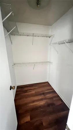 a view of a room with wooden floor and a window