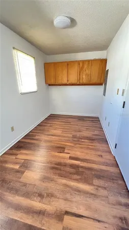 a view of a room with wooden floor and a window