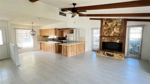 a view of kitchen with microwave stove top oven and cabinets