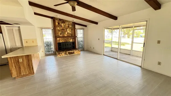 a kitchen with stainless steel appliances granite countertop a refrigerator a sink dishwasher a stove and a wooden floor