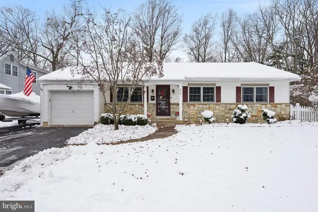 a view of a house with a yard covered in snow