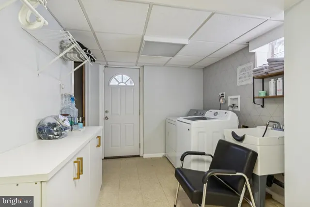 a utility room with a sink dryer and washer