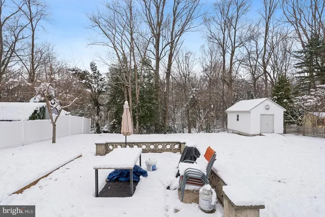 a view of a white house and a yard with snow