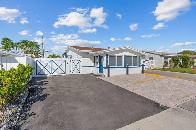a large white kitchen with cabinets and a sink