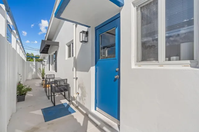a bedroom with a bed and next to a window