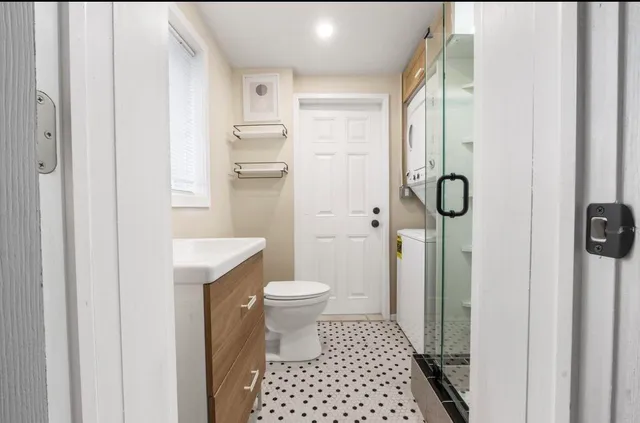 a bathroom with a toilet sink and a mirror