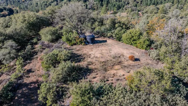 a view of a city with lush green hillside