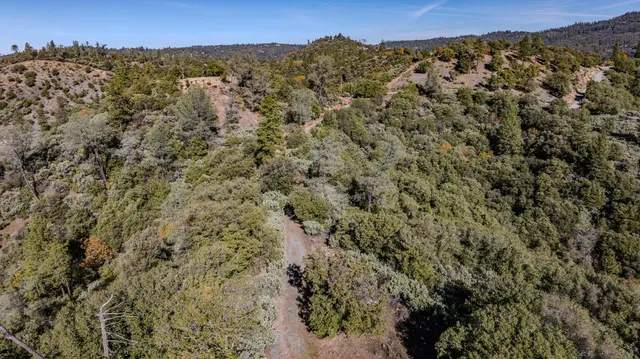 an aerial view of residential house and sandy dunes