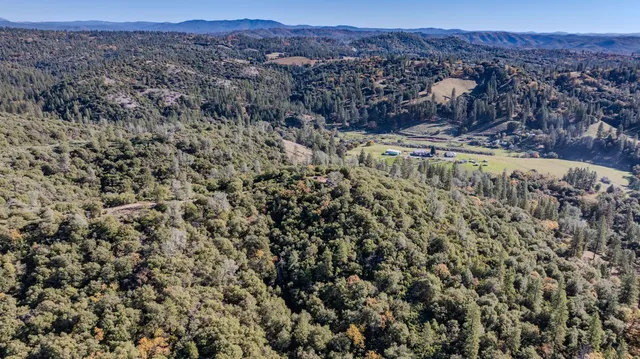 an aerial view of a house with a street