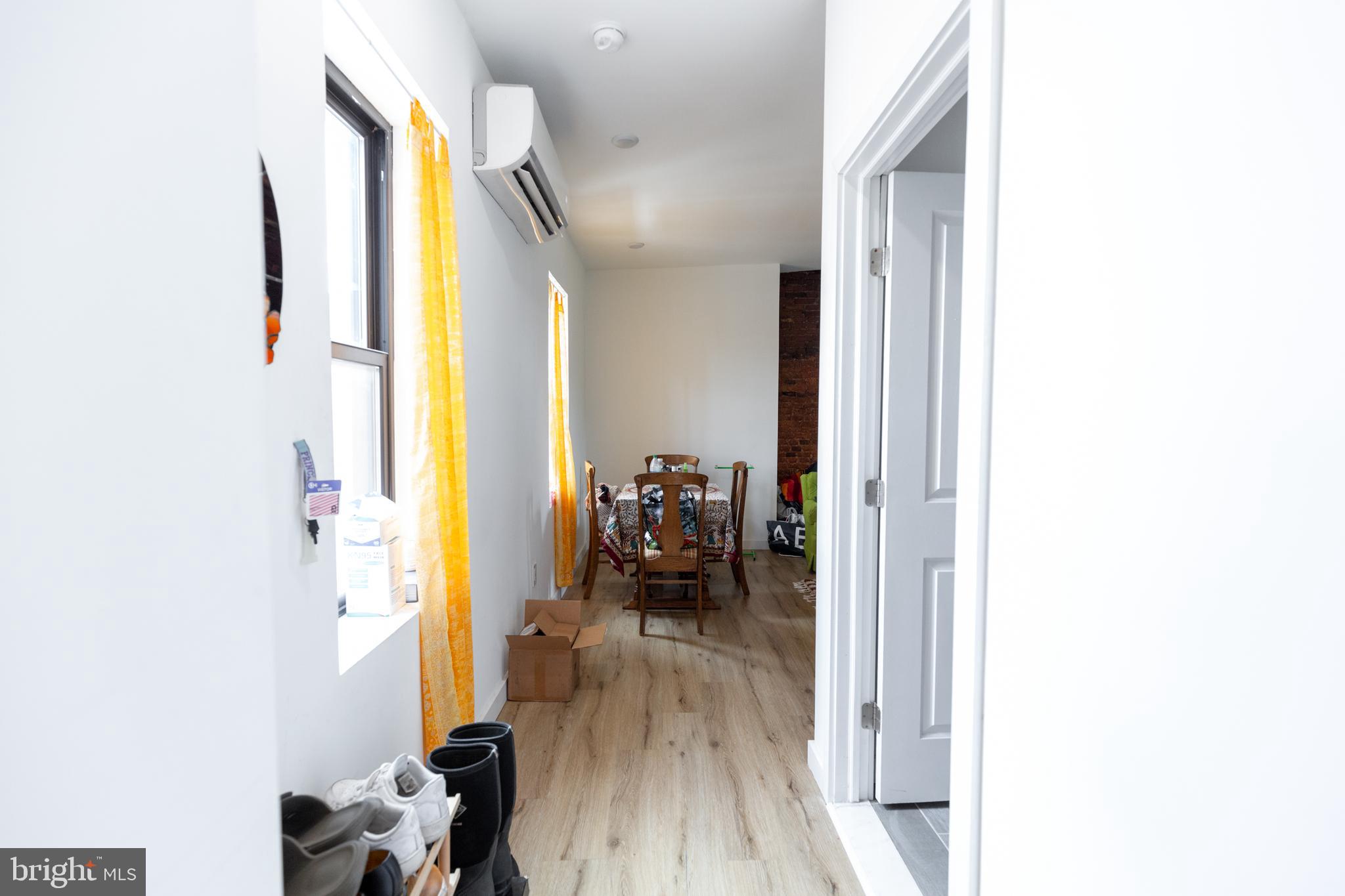 3945-49 Lancaster Avenue, Unit 3B Philadelphia, PA 19104 - Photo 12 of 28 a view of a hallway with wooden floor and a living room