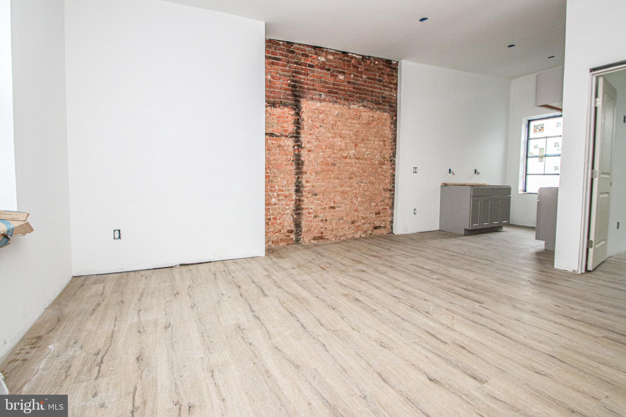 3945-49 Lancaster Avenue, Unit 3B Philadelphia, PA 19104 - Photo 2 of 28 an empty room with wooden floor and windows