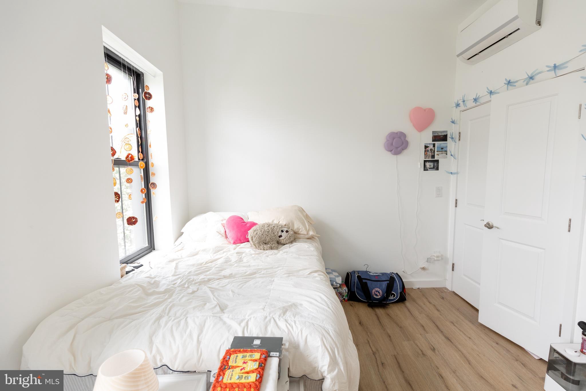 3945-49 Lancaster Avenue, Unit 3B Philadelphia, PA 19104 - Photo 22 of 28 a bedroom with a bed and a window