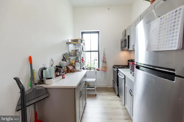 a kitchen with sink cabinets and window