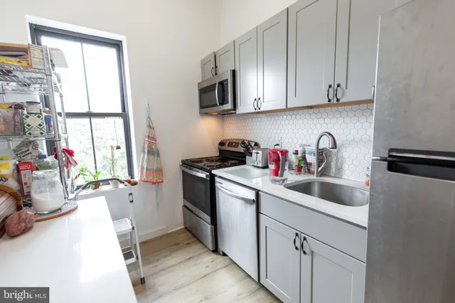 a view of a kitchen and workspace