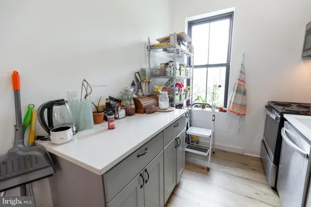 a kitchen with a sink dishwasher and a refrigerator