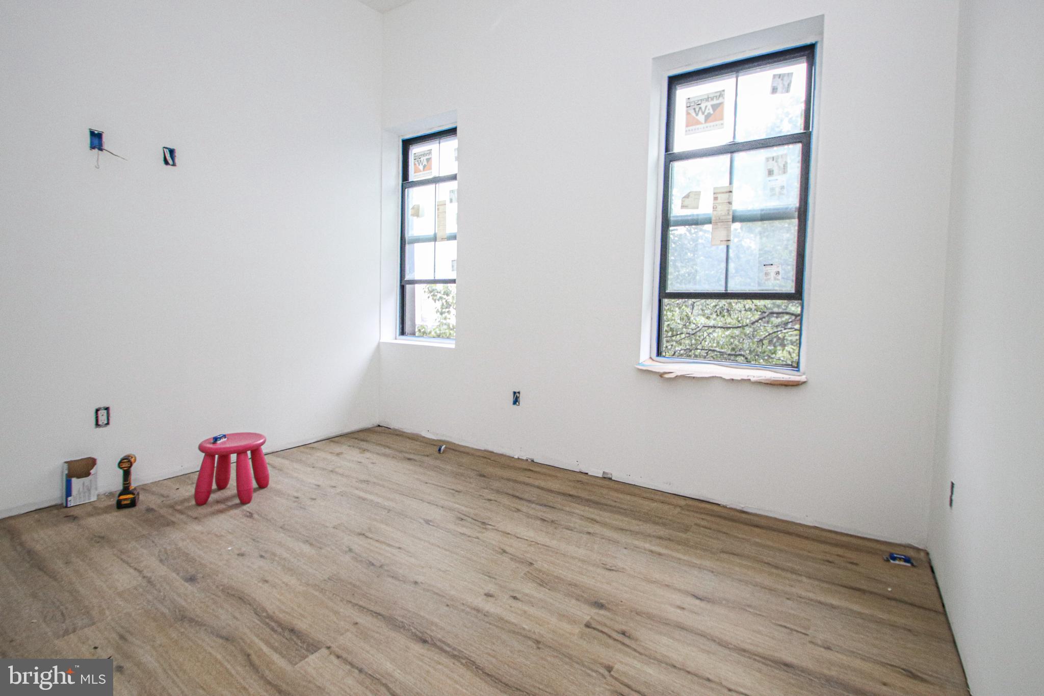 3945-49 Lancaster Avenue, Unit 3B Philadelphia, PA 19104 - Photo 4 of 28 an empty room with wooden floor and windows