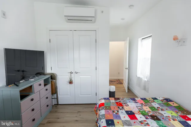 a bedroom with bed and flat screen tv