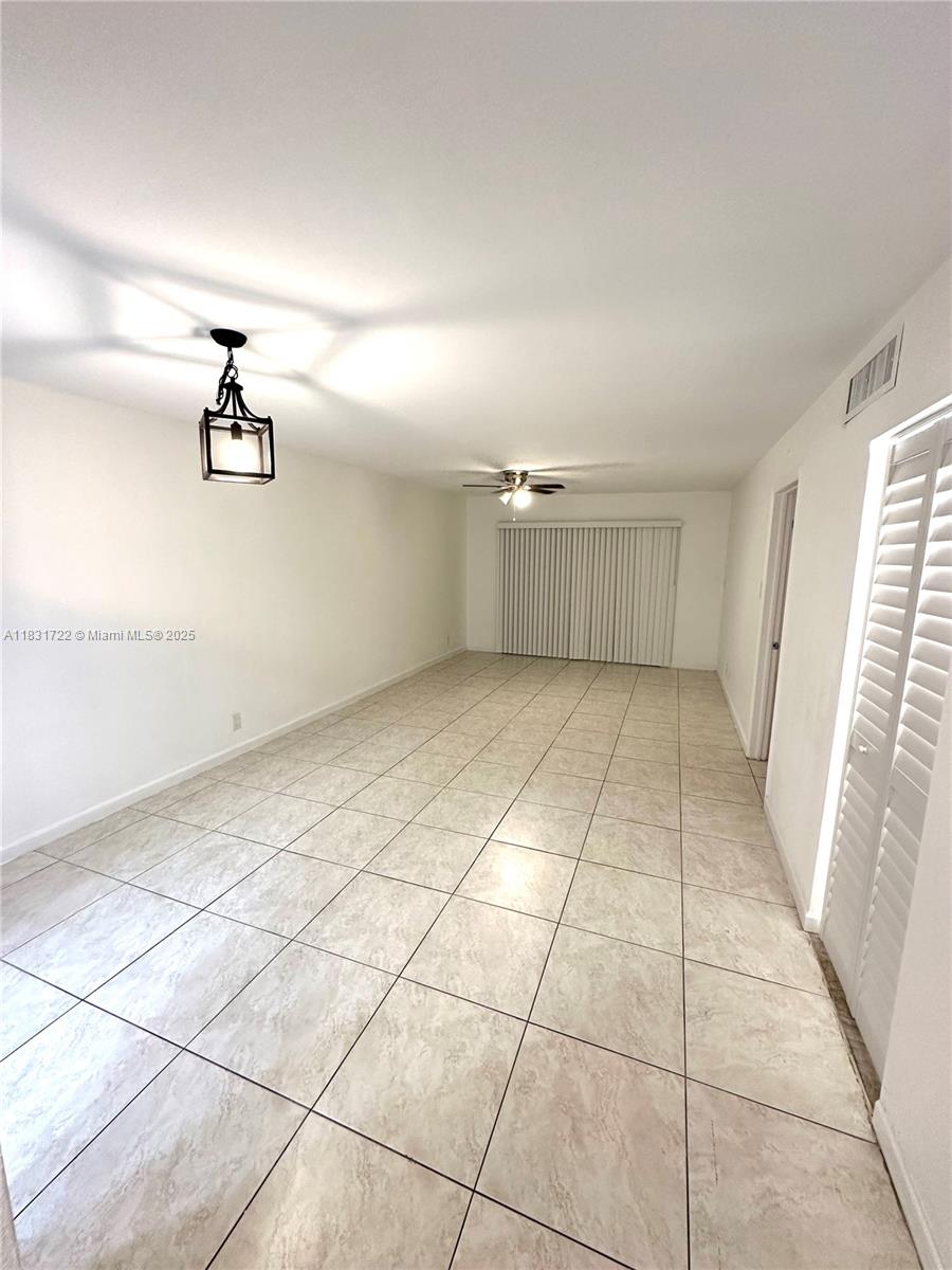 603 South State Road 7, Unit 1D Margate, FL 33068 - Photo 4 of 12 a view of a livingroom with wooden floor and a window