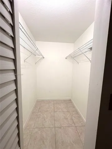 a bathroom with a granite countertop toilet a sink and a mirror