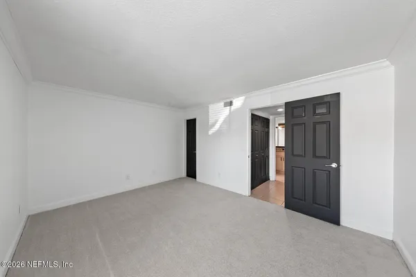 a living room with furniture gym equipment and a large window