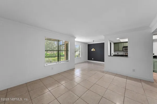 a living room with furniture a chandelier and a fireplace