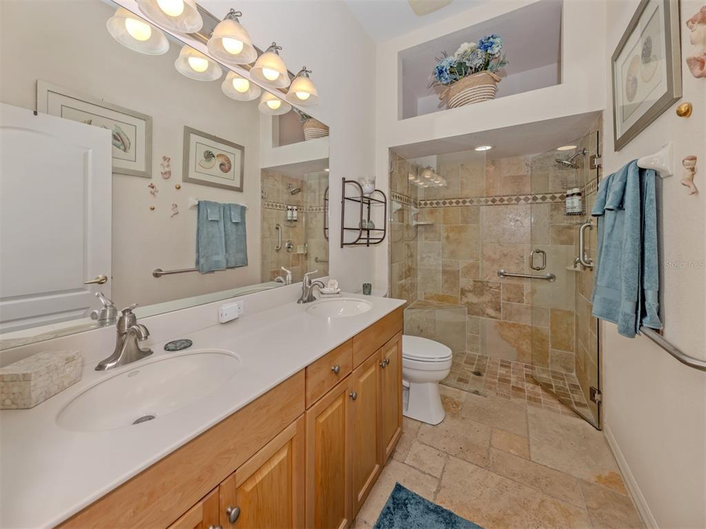 205 Reclinata Circle Venice, FL 34292 - Photo 26 of 62 a spacious bathroom with a double vanity sink mirror double and shower