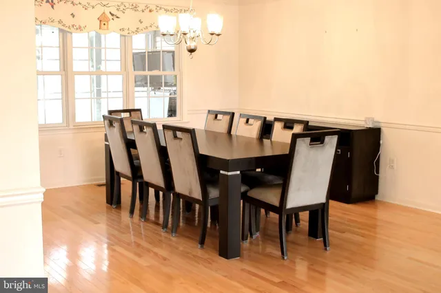 a kitchen with a stove cabinets and chairs