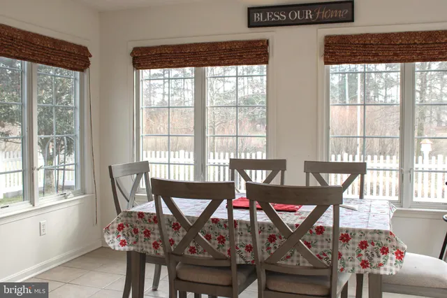 a view of a dining room with furniture and windows