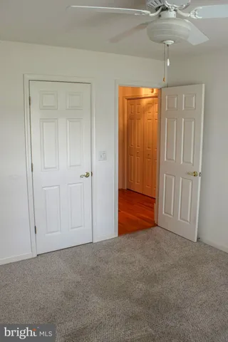 a room with a walk in closet and a couch