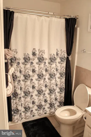 a living room with a large window and a flat screen tv