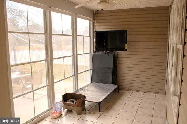 a sign that is sitting in front of a house with a yard