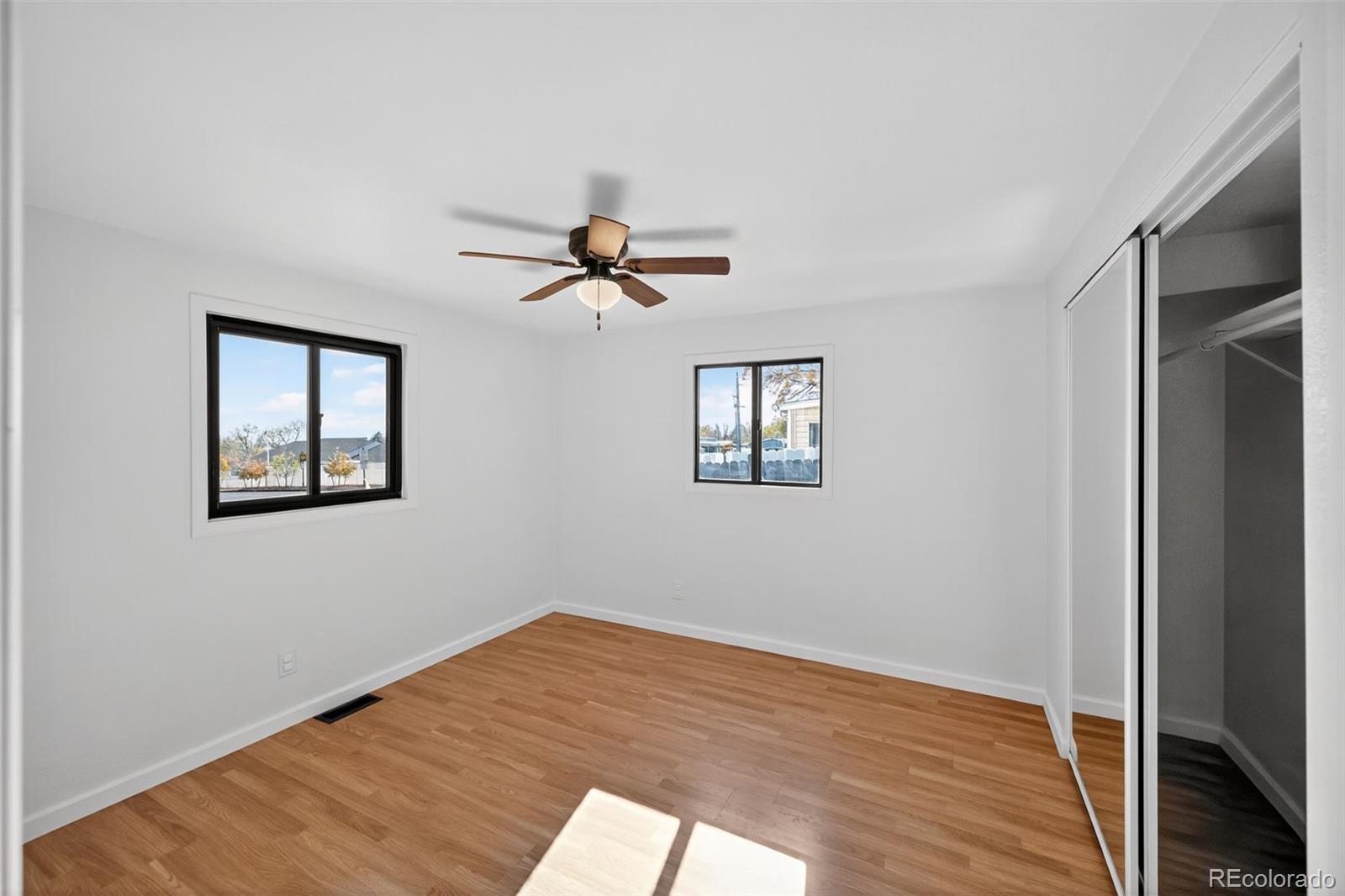 2000 Moselle Street Denver, CO 80260 - Photo 13 of 33 a view of empty room with wooden floor and fan
