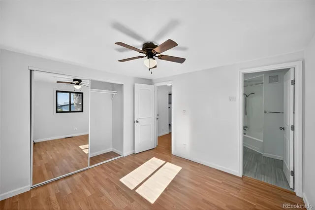 a view of a room with wooden floor and windows