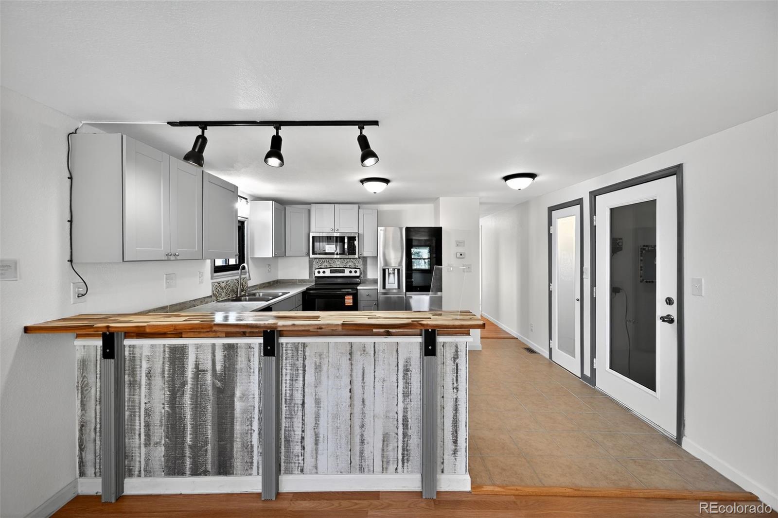 2000 Moselle Street Denver, CO 80260 - Photo 16 of 33 a kitchen with stainless steel appliances granite countertop a sink and a refrigerator