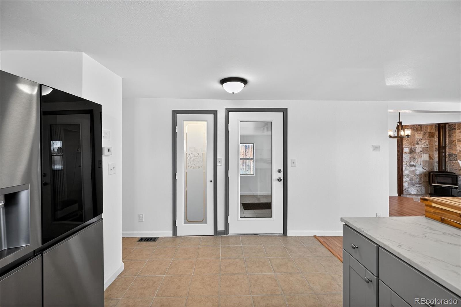 2000 Moselle Street Denver, CO 80260 - Photo 17 of 33 a view of a hallway to a livingroom and a livingroom with furniture