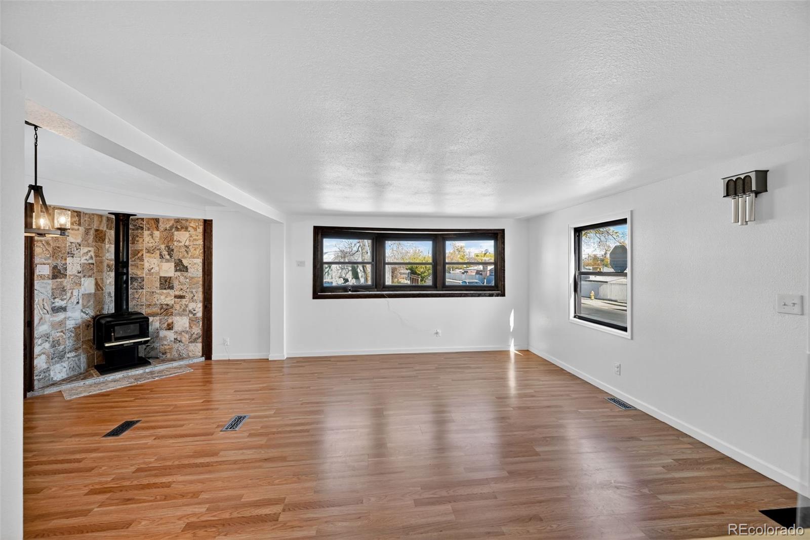 2000 Moselle Street Denver, CO 80260 - Photo 20 of 33 wooden floor in an empty room with a window